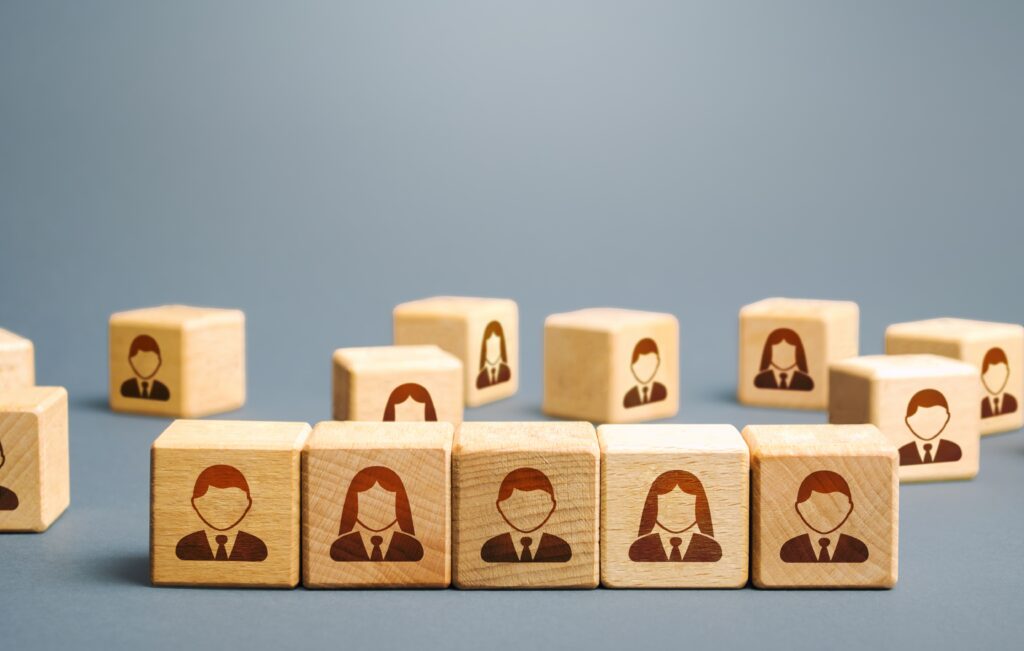 Wooden blocks with employee figure: illustrating how White Label agency can foster growth without hiring more staff.